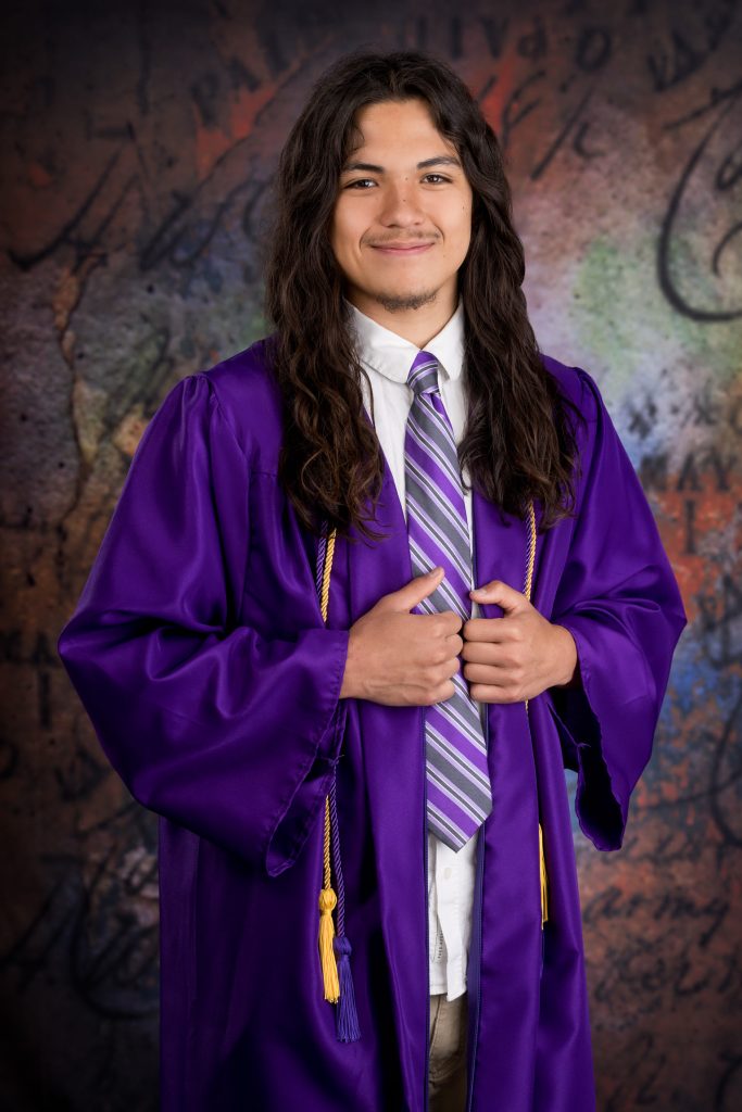 Cap-and-gown graduation portrait of a high school senior in the Blue Ridge Expressions studio.